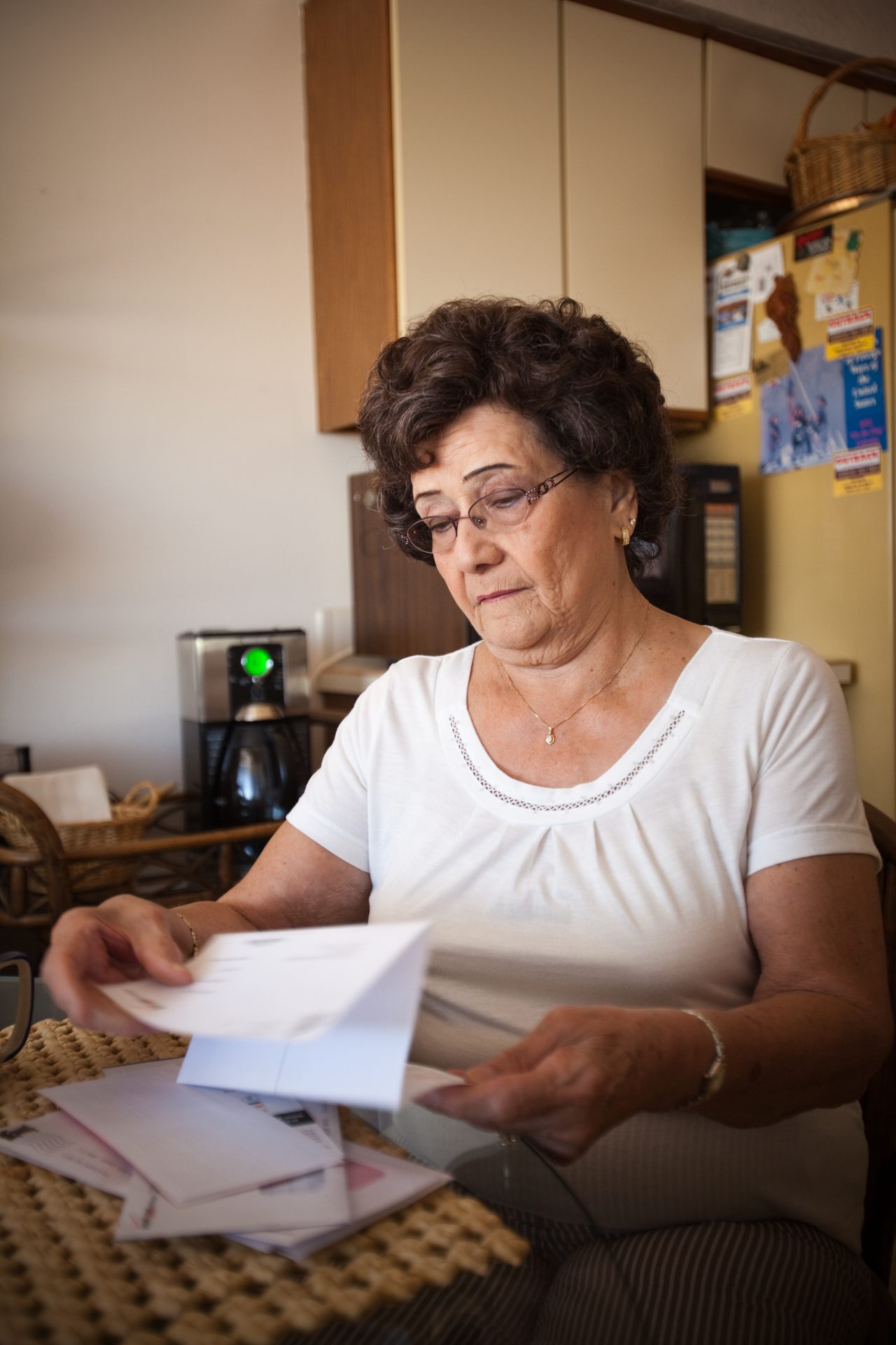 Carmen Boatner reading mail and bills at home.in her home in Tucson, Arizona. Carmen suffers from Alzheimer's.
