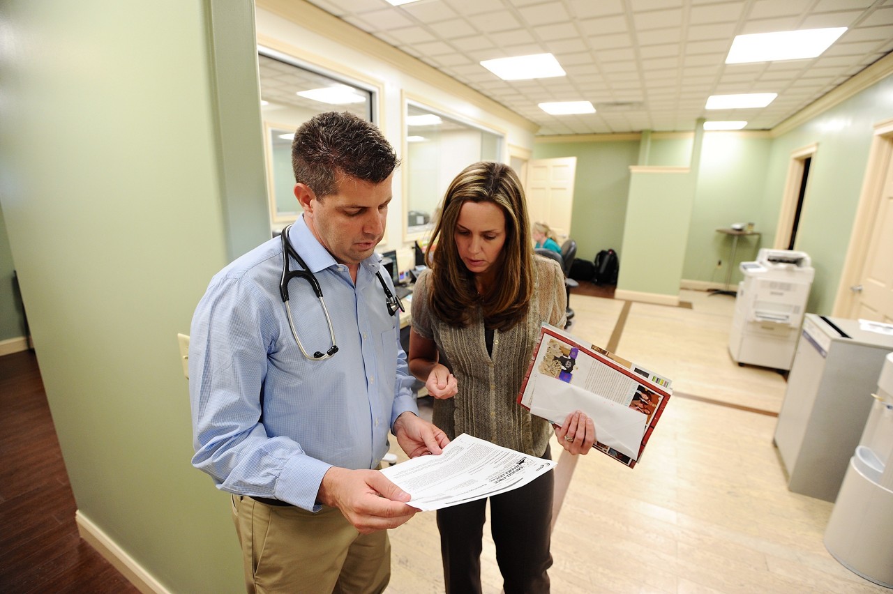 Dr Donovan  Dino  Beckett consults with his wife Stacy  at his practice the
Williamson Health and Wellness Center,
Williamson W.Va., Wed, May 28, 2014. (AP Photo/Tyler Evert), Dr. Donovan “Dino” Beckett consults with his wife, Stacy, at his practice in the Williamson Health and Wellness Center.