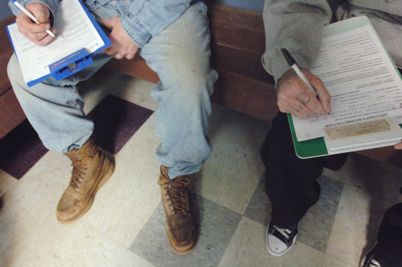 Patients complete paperwork in a waiting room.