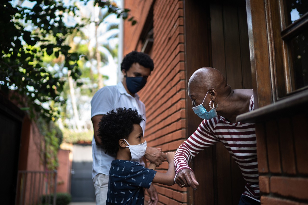 Grandmother and grandson using elbow greeting