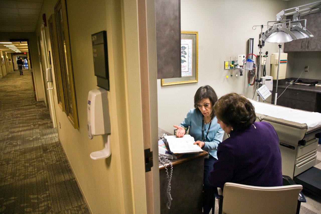 A health care provider goes over paperwork with a patient.