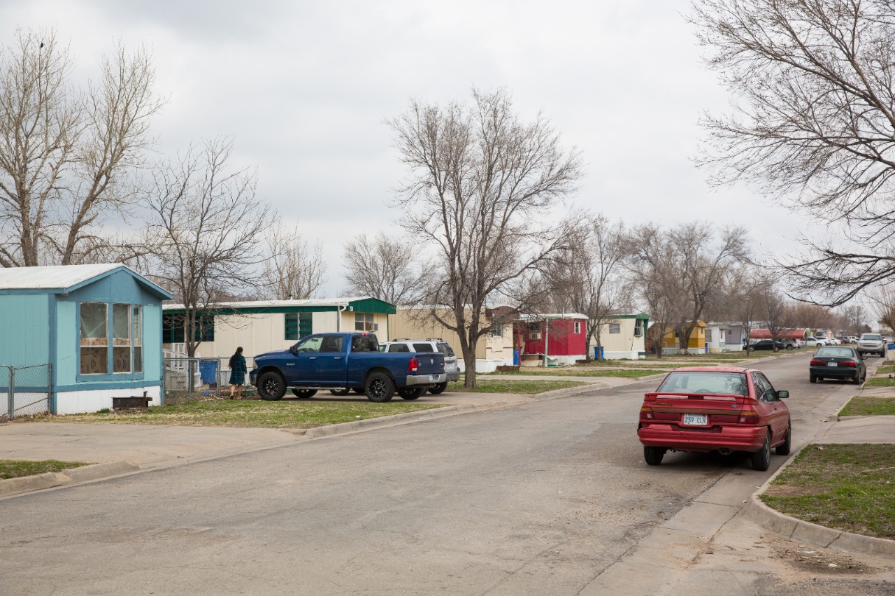 Mobile homes at East Village Garden in Garden City, Kansas.  The mobile home park was developed in the early 1980s to create low-cost housing for the influx of workers coming to work at the IBP Inc. meatpacking plant (now Tyson Fresh Meats).  Many of the park’s residents are Southeast Asian and Hispanic immigrants.