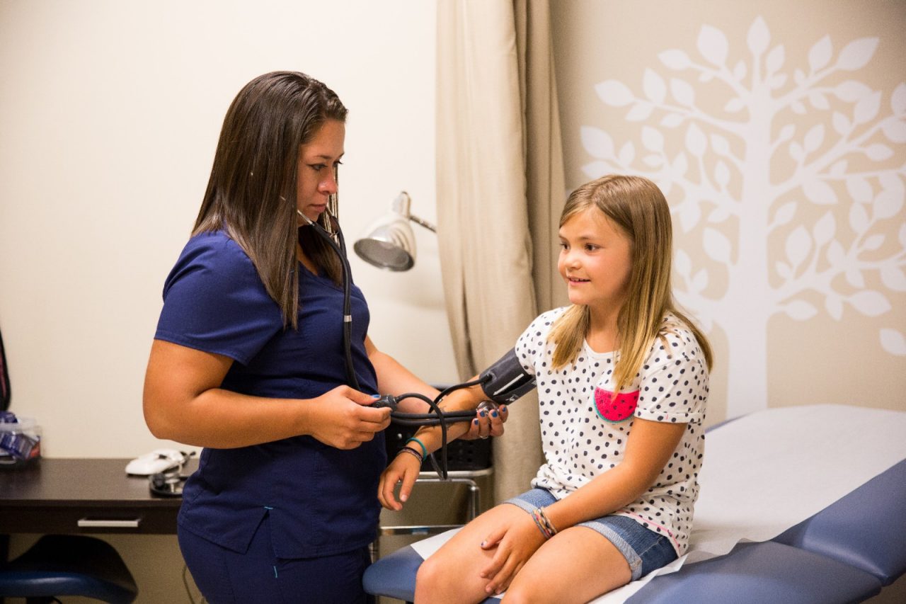 Nurse Melanie Hernandez takes 8 year old patient Ryden Hofer's blood pressure during a checkup at the School Based Health Center at Lake County High School in Leadville, Colorado. The School Based Health Center provides medical care and mental health services to students, teachers and families in the district.