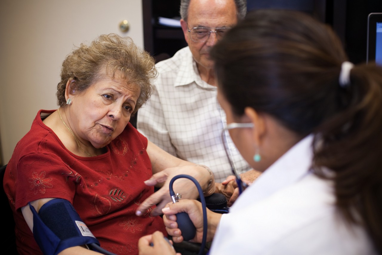 Woman taking patient's blood pressure. A woman takes a patient's blood pressure.