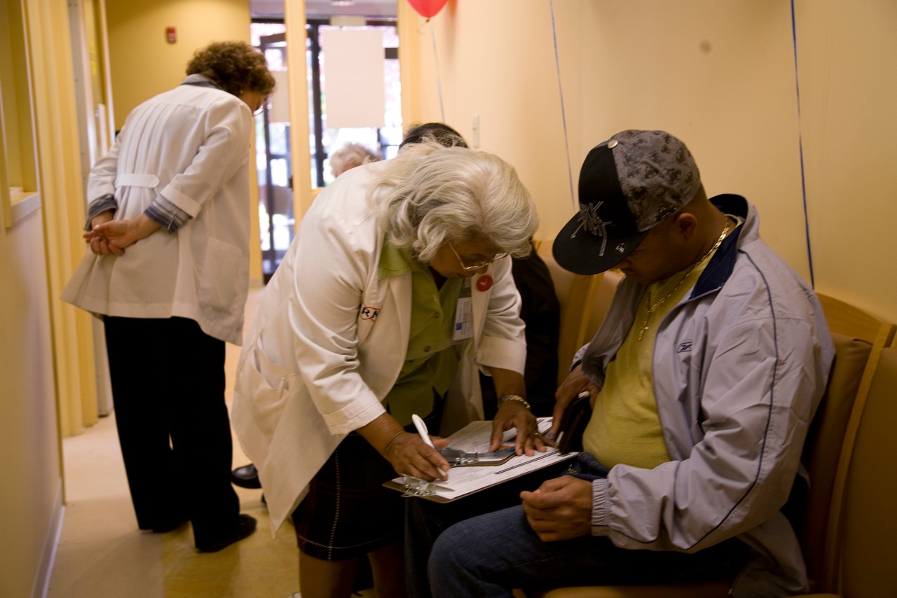 Vote & Vax, a collaboration between the Robert Wood Johnson Foundation and SPARC, works with local public health providers to offer convenient flu vaccinations at polling places on election day across the country. These photographs were all made at the Southend Senior Wellness Center in Hartford, Connecticut.

Hartford is a diverse community made up of primarily of African Americans, ethnic Caucasians and Asian Americans, it also has large Bosnian and Brazilian immigrant communities. Thirty percent of the population lives below the poverty line, Hartford's rate of poverty is second in the United States only to Brownsville, Texas according to the last US Census Bureau's brief. The election department has informed them that a 2,500 person senior center does all its voting at this polling site, and this senior center has not done any vaccine clinics this season.

Laurie St John described as a "whirling dervish" by her co-workers tried unsuccessfully to start a Vote & Vax for the last few elections. She faced many challenges. It wasn't until a conversation with Tung Nyguen, DPH epidemiologist, which lead to a partnership between the Hartford VNA and Hartford DPH. This year is the 1st Hartford Vote & Vax a joint effort between VNA and DPH.

They have 1500 vaccines on site. They are doing shifts so nurses can vote. There will be bilingual translators on site. Vote & Vax greeters will be interacting with voters on line and in parking lot to help voters know that vaccines are available. Surveys will be conducted with vaccine recipients as they exit clinic as a part of the Vote & Vax results data requirement. Voting and Vote & Vax clinic will take place in separate areas on the 1st floor of the building, accessible through separate exterior entrances. There have been ads in the papers.  Anthem is providing free vaccinations to the uninsured., Vote & Vax, a collaboration between the Robert Wood Johnson Foundation and SPARC, works with local public health providers to offer convenient flu vaccinations at polling places on election day across the country. These photographs were all made at the Southend Senior Wellness Center in Hartford, Connecticut.

Hartford is a diverse community made up of primarily of African Americans, ethnic Caucasians and Asian Americans, it also has large Bosnian and Brazilian immigrant communities. Thirty percent of the population lives below the poverty line, Hartford's rate of poverty is second in the United States only to Brownsville, Texas according to the last US Census Bureau's brief. The election department has informed them that a 2,500 person senior center does all its voting at this polling site, and this senior center has not done any vaccine clinics this season.

Laurie St John described as a "whirling dervish" by her co-workers tried unsuccessfully to start a Vote & Vax for the last few elections. She faced many challenges. It wasn't until a conversation with Tung Nyguen, DPH epidemiologist, which lead to a partnership between the Hartford VNA and Hartford DPH. This year is the 1st Hartford Vote & Vax a joint effort between VNA and DPH.

They have 1500 vaccines on site. They are doing shifts so nurses can vote. There will be bilingual translators on site. Vote & Vax greeters will be interacting with voters on line and in parking lot to help voters know that vaccines are available. Surveys will be conducted with vaccine recipients as they exit clinic as a part of the Vote & Vax results data requirement. Voting and Vote & Vax clinic will take place in separate areas on the 1st floor of the building, accessible through separate exterior entrances. There have been ads in the papers.  Anthem is providing free vaccinations to the uninsured.