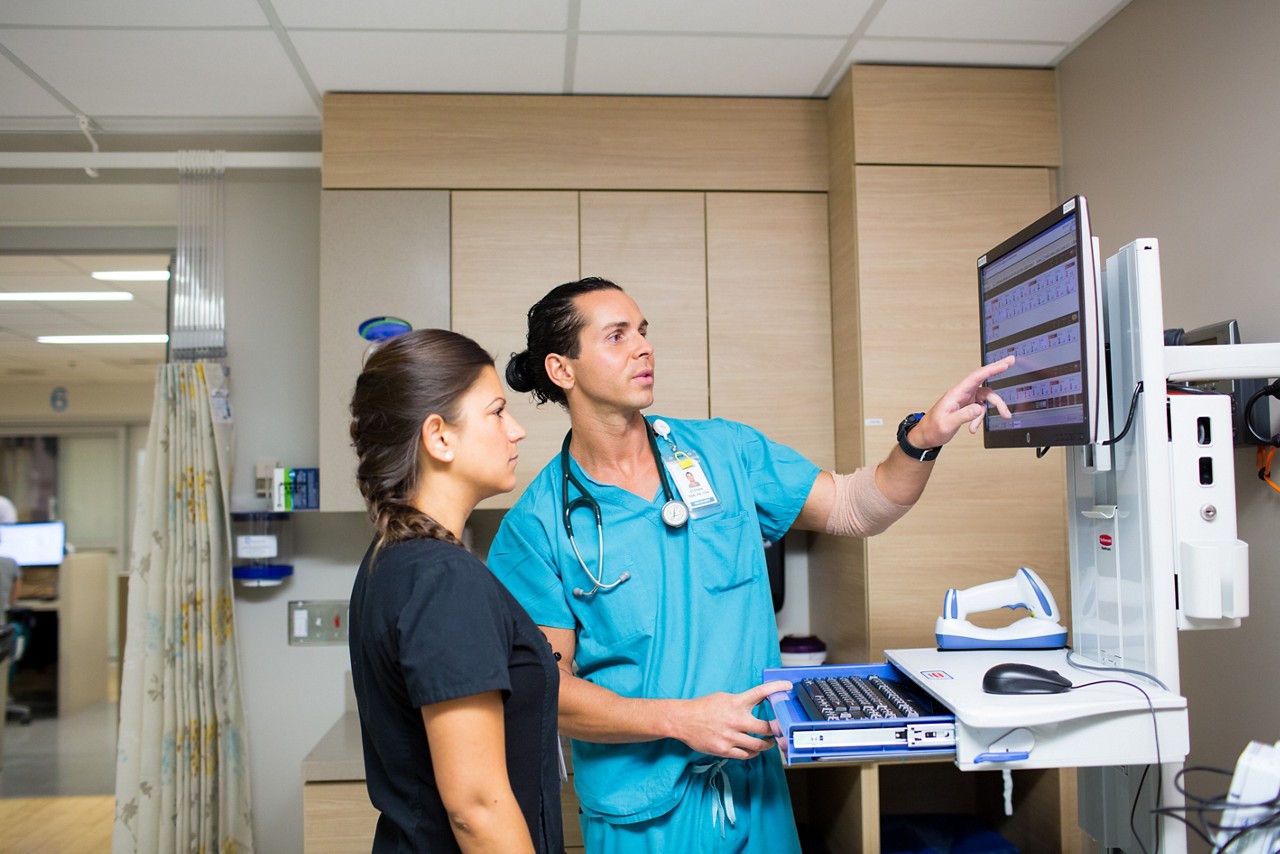 Nurses use a computer to monitor patients.