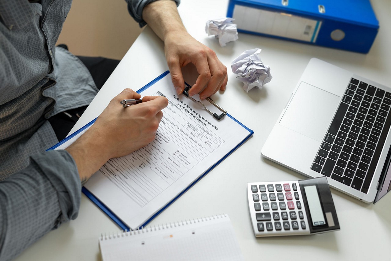 Man completing a claim form.
