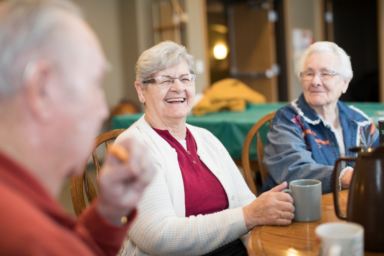 Older adults enjoying comradery in recreation room.