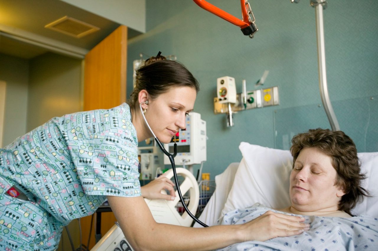  A nurse monitoring a hospital patient.