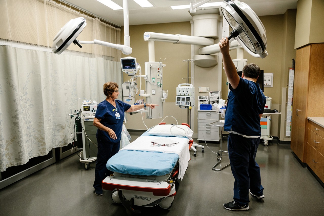 Nurses prep an emergency exam room. 