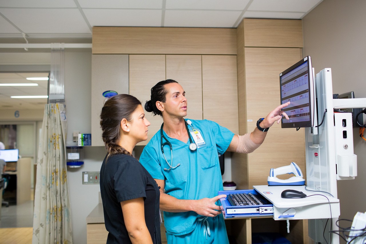 Nurses use a computer to monitor patients.