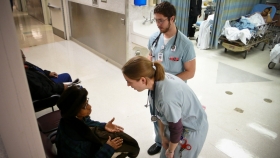 Health professionals talking with a patient in a hospital. Health professionals talking with a patient in a hospital.